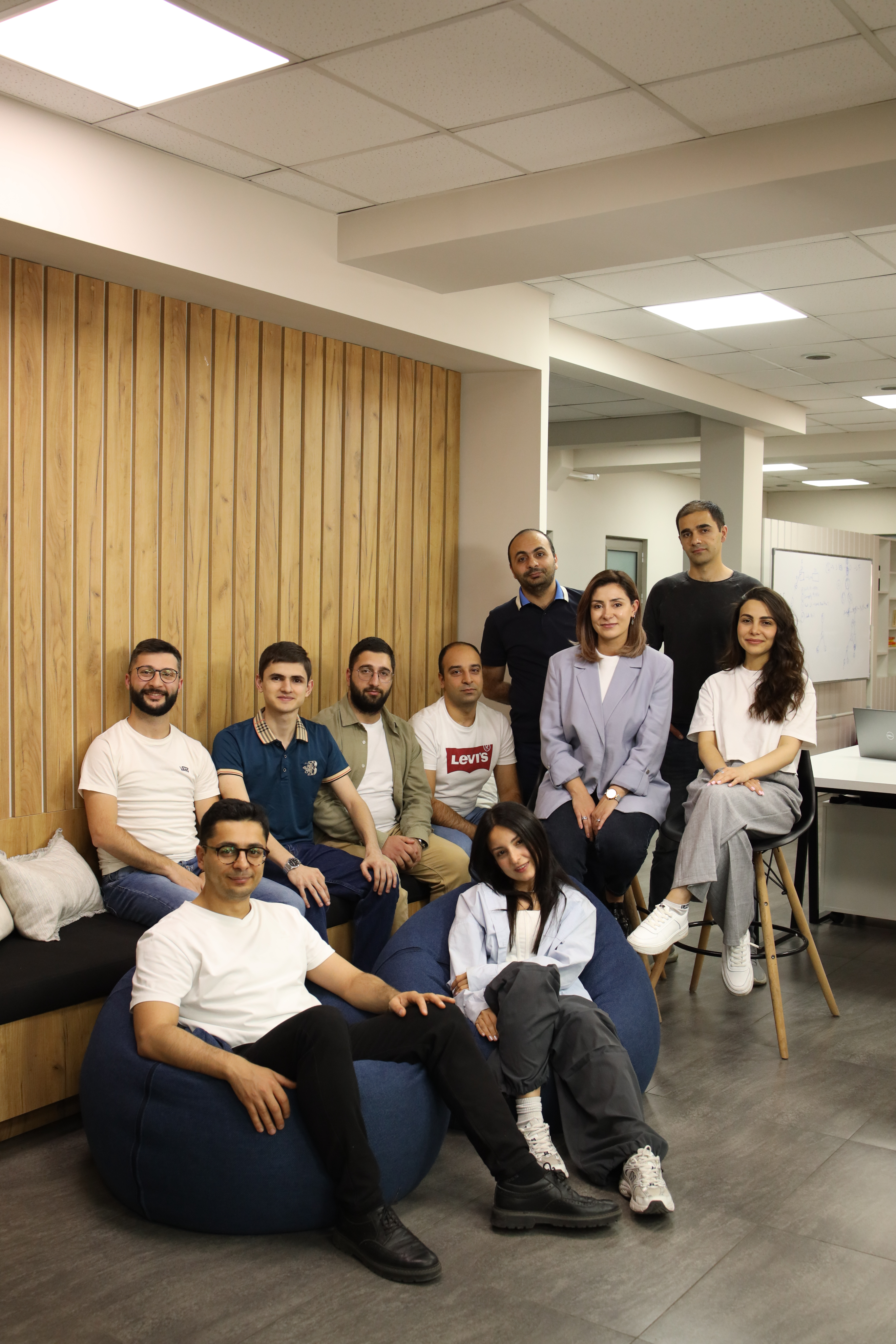 Two women sitting together at a table, looking at documents or a screen.